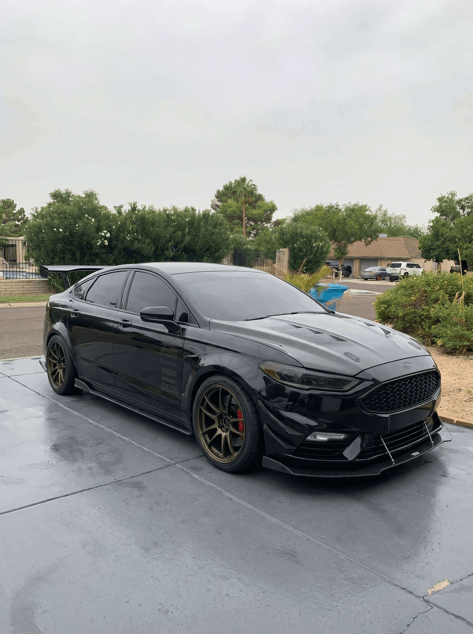 Murdered-out Ford Fusion on bronze wheels